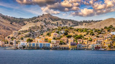 View of the beautiful greek island of Symi (Simi) with colourful houses and small boats. Greece, Symi island, view of the town of Symi (near Rhodes), Dodecanese.