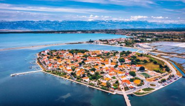 Historic town of Nin laguna aerial view with Velebit mountain background, Dalmatia region of Croatia. Aerial view of the famous Nin lagoon and medieval in Croatia