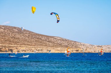 Surfers in Prasonisi Beach in Rhodes island, Greece. Kiteboarder kitesurfer athlete performing kitesurfing kiteboarding tricks. Prasonisi Beach is popular location for surfing. Greece