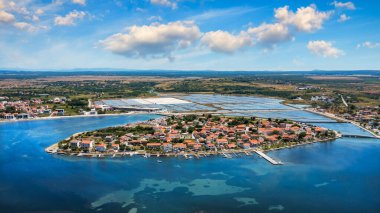 Historic town of Nin laguna aerial view with Velebit mountain background, Dalmatia region of Croatia. Aerial view of the famous Nin lagoon and medieval in Croatia clipart