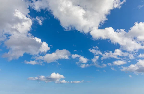 Sunny sky abstract background, beautiful cloudscape, on the heaven, view over white fluffy clouds, freedom concept. Aerial view of sky and white clouds. View from airplane. 
