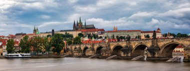 Prague Castle, Charles Bridge and boats on the Vltava river. View of Hradcany Prague Castle, Charles Bridge and a boats on the Vltava river in the capital of the Czechia. 