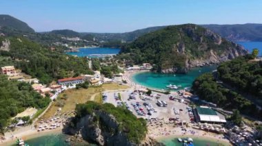 Picturesque seaside of Paleokastritsa, Corfu, Greece. Beautiful bay in Paleokastritsa in Corfu island, Greece. Panoramic view of Palaiokastritsa, boats and beach Corfu, Greece