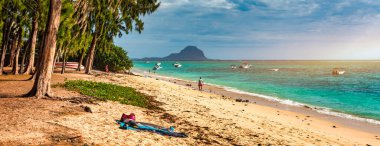 Beach of Flic en Flac with beautiful peaks in the background, Mauritius. Beautiful Mauritius Island with gorgeous beach Flic en Flac. Flic en Flac Beach, Mauritius Island. clipart