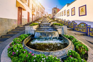Famous Paseo de Canarias street on Firgas, Gran Canaria, Canary Islands, Spain. Fountain of natural mineral water in Firgas, Gran Canaria. Village Firgas at Gran Canaria, Paseo de Canarias clipart