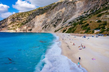 Aerial drone view of iconic turquoise and sapphire bay and beach of Myrtos, Kefalonia (Cephalonia) island, Ionian, Greece. Myrtos beach, Kefalonia island, Greece. Beautiful view of Myrtos beach. clipart