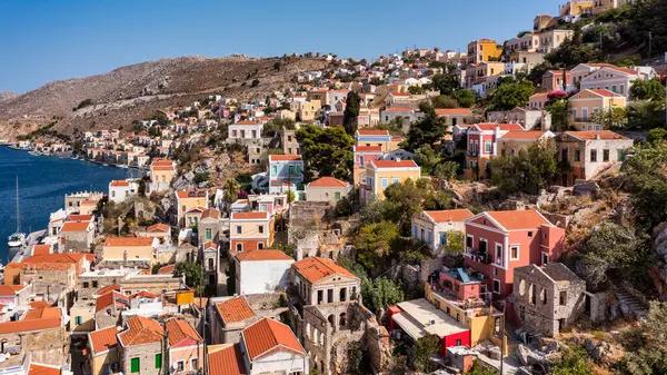 Stock image Aerial view of the beautiful greek island of Symi (Simi) with colourful houses and small boats. Greece, Symi island, view of the town of Symi (near Rhodes), Dodecanese.