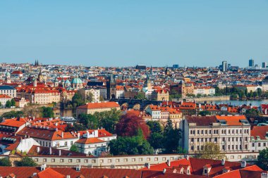 View of Prague featuring vibrant rooftops on a sunny day in summer. Aerial view of Prague, Charles Bridge over Vltava river in Prague, Czechia. Old Town of Prague, Czech Republic. clipart