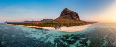 Aerial view of Le morne Brabant in Mauriutius. Tropical crystal ocean with Le Morne mountain and luxury beach in Mauritius. Le Morne beach with palm trees, white sand and luxury resorts, Mauritius. clipart