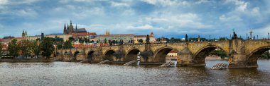 Prague Castle, Charles Bridge and boats on the Vltava river. View of Hradcany Prague Castle, Charles Bridge and a boats on the Vltava river in the capital of the Czechia. 