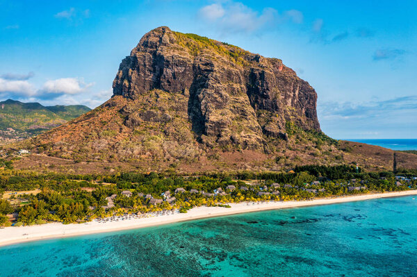 Aerial view of Le morne Brabant in Mauriutius. Tropical crystal ocean with Le Morne mountain and luxury beach in Mauritius. Le Morne beach with palm trees, white sand and luxury resorts, Mauritius.
