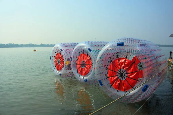 Floating water walking balloons or zorbing ballons on lake water.