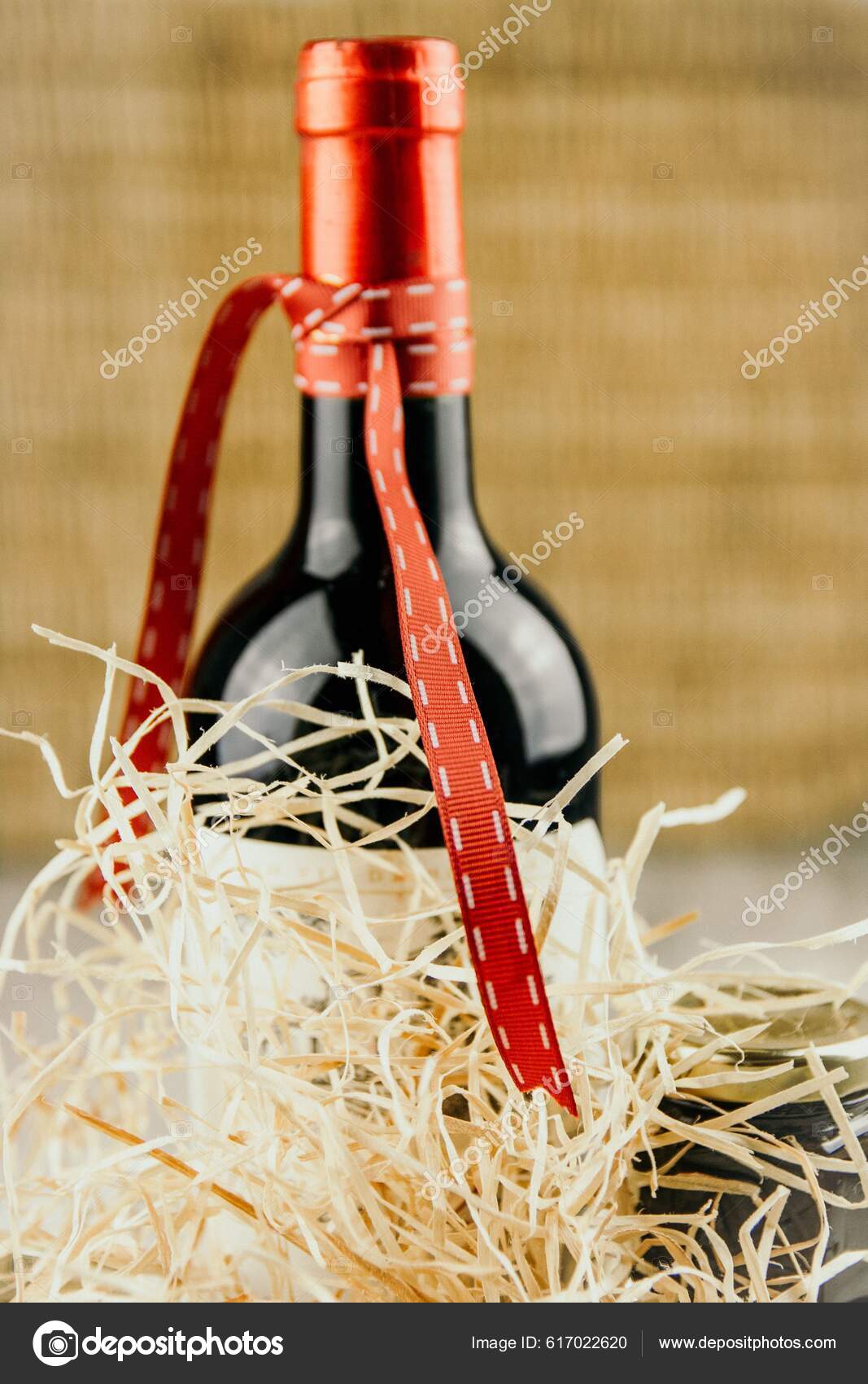 https://st5.depositphotos.com/67903508/61702/i/1600/depositphotos_617022620-stock-photo-vertical-shot-bottle-wine-ribbon.jpg
