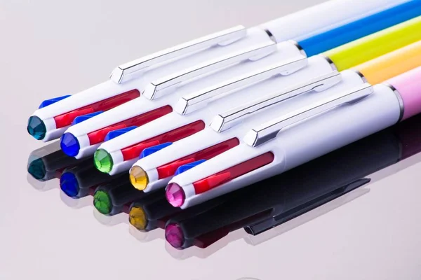 许多彩色钢笔放在反光桌子上 — 图库照片