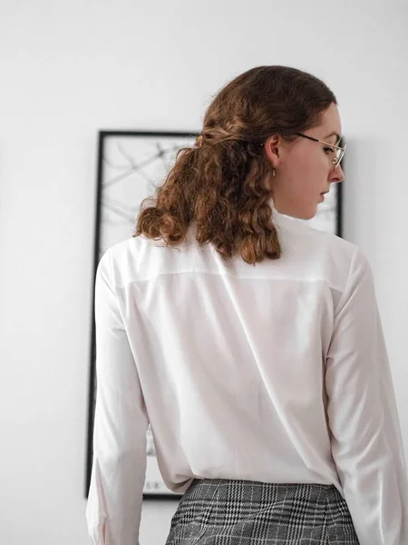 白いTシャツと無線のイヤホンを身に着けている若い女性の垂直ショット — ストック写真