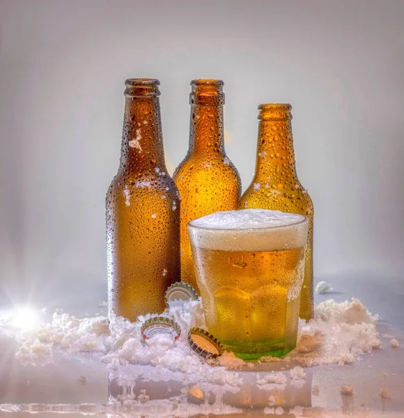 Three Glass Bottles Cold Beer Cup Pile Smashed Ice Isolated — Stock Photo, Image