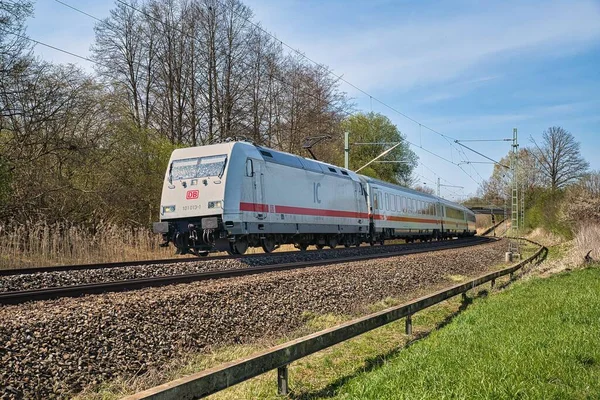 stock image A white train intercity travels through Ostermuenchen with series 101