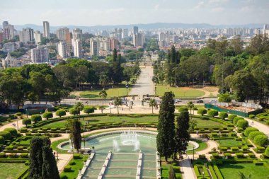 high angle view of Ipiranga Museum garden and fountains with Sao Paulo cityscape as backdrop, Brazil clipart