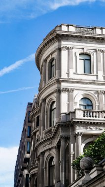 Londra 'da mavi gökyüzünün altındaki tarihi bir binanın güzel dikey görüntüsü.