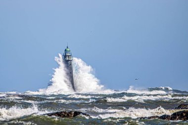 The ocean waves crash into the Minot's Ledge Light lighthouse in Scituate, Massachusetts. clipart