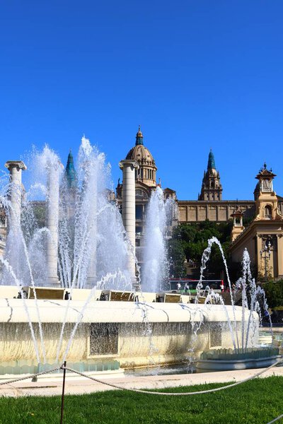 An aerial view of fountain in background of buildings in Barcelona