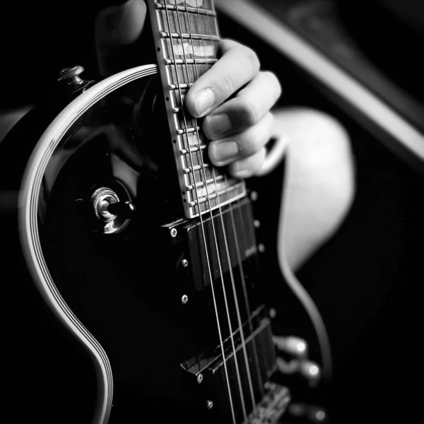 Grayscale Closeup Shot Electric Guitar Person Hand Holding Its Fretboard — Stock Photo, Image
