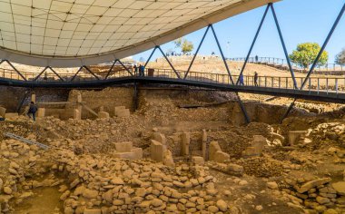 Türkiye 'nin Urfa yakınlarındaki Göbeklitepe arkeoloji sahasında, güneşli bir günde arkeoloji kazı sığınağının altında