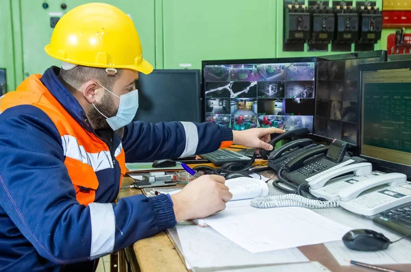 stock image A male working with yellow helmet and protective mask