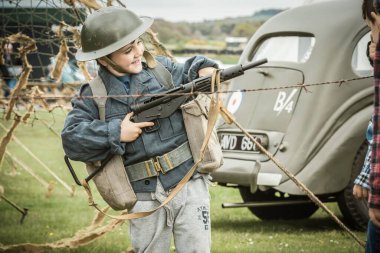 A cute child in a military uniform at the Victory in Europe Day 70th Anniversary Commemoration Event clipart