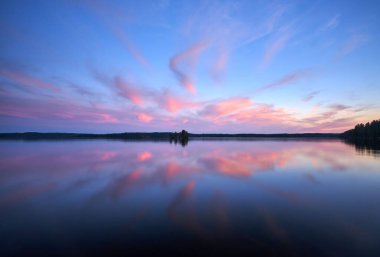 A beautiful view of a calm lake at scenic sunset