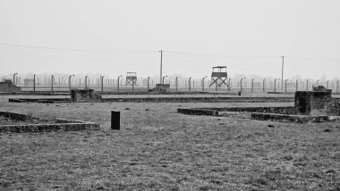 A grayscale view of the exterior landscape of the Auschwitz concentration camp in Oswiecim, Poland clipart