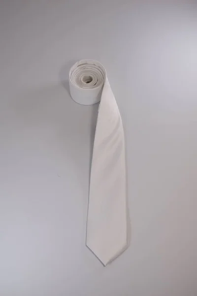 白い背景に隔離された白いネクタイの垂直ショット — ストック写真