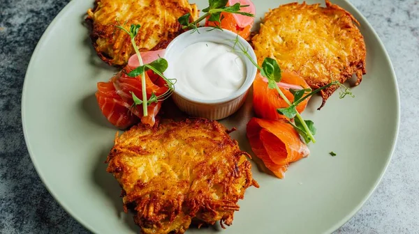 stock image A delicious potato pancakes served with sauce