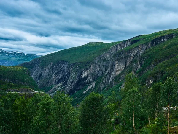 Ένα Βραχώδες Βουνό Πλαγιές Καλυμμένες Γρασίδι Περιτριγυρισμένο Από Πράσινα Δέντρα — Φωτογραφία Αρχείου