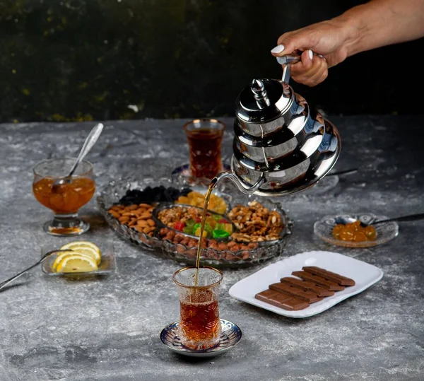 Closeup Shot Hand Pouring Out Tea Turkish Chai Glass Silver — Stock Photo, Image