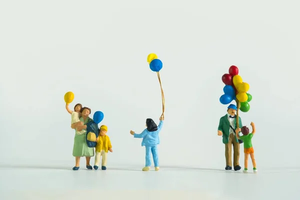Close Figuras Miniatura Homem Crianças Com Balões Isolados Fundo Branco — Fotografia de Stock