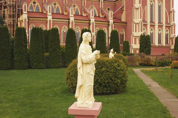 Church of the Holy Trinity in Gierviaty under a reconstruction. Apostle statue. Cloudy day