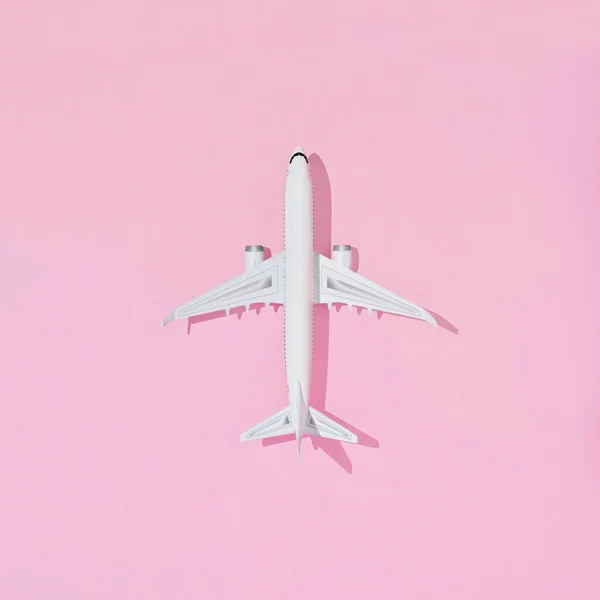 stock image A top view 3D of an airplane isolated on a pink pastel background - summer travel concept