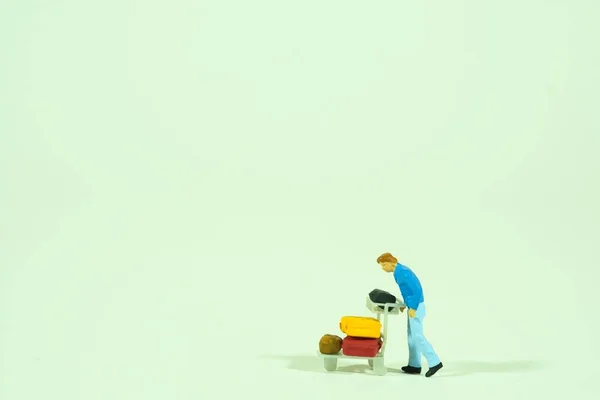 Traveling people with luggage, white background, miniature figures scene