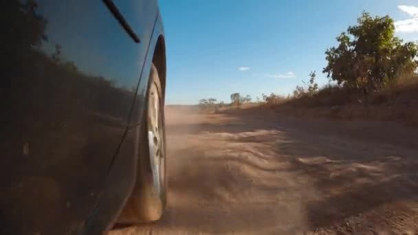 Closeup Car Low Part Showing Back Tire Driving Dirt Road — Stock Video