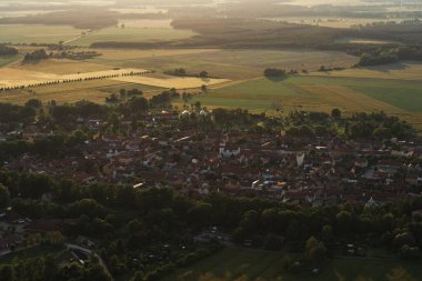 Bir yerleşim bölgesi ve tarım arazisi üzerinde manzaralı bir hava manzarası