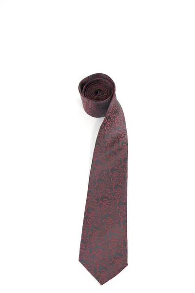 stock image A vertical shot of a black necktie with a red pattern isolated on a white background.