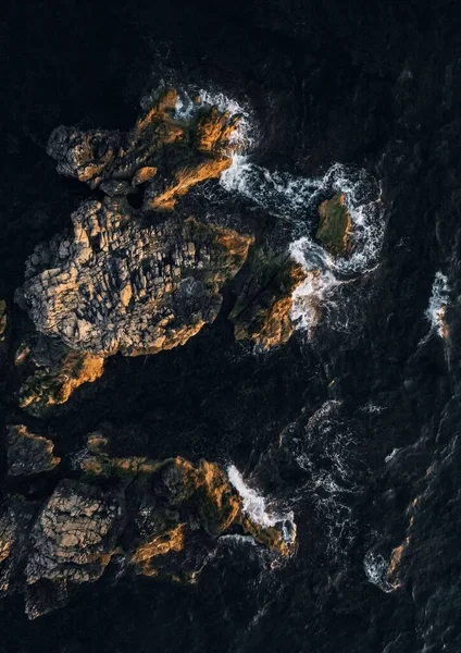 岩に衝突する海の波の上の垂直方向のトップビュー — ストック写真