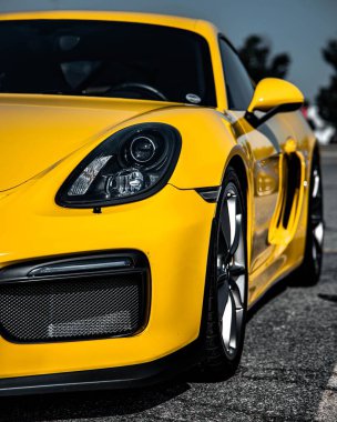 Büyüleyici sarı Porsche Cayman 'ın dış yüzey spor arabasının dikey görüntüsü