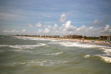 An aerial view of sea waves breaking sandy beach