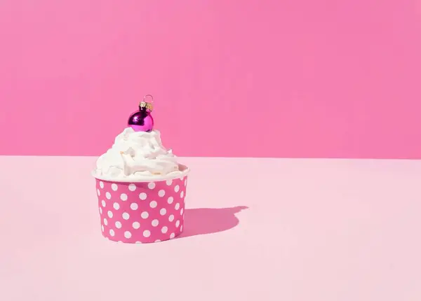 Cupcake Med Vispad Grädde Och Julkula Prydnad Rosa Bakgrund — Stockfoto