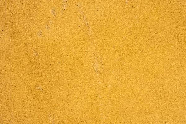 ざらざらとしたグランジの質感の黄色の壁の背景の閉鎖 — ストック写真
