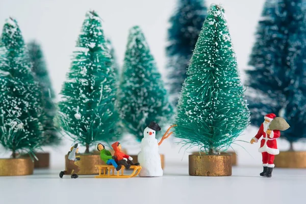 Miniature figurines of family on white background stock photo