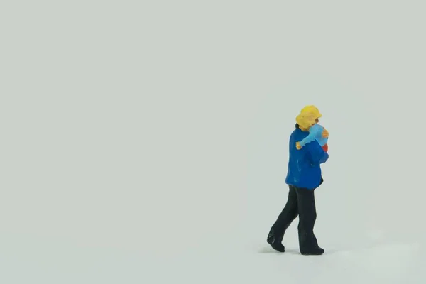 Мініатюрна Фігура Пожежника Йде Білому Тлі Тримає Дитину — стокове фото