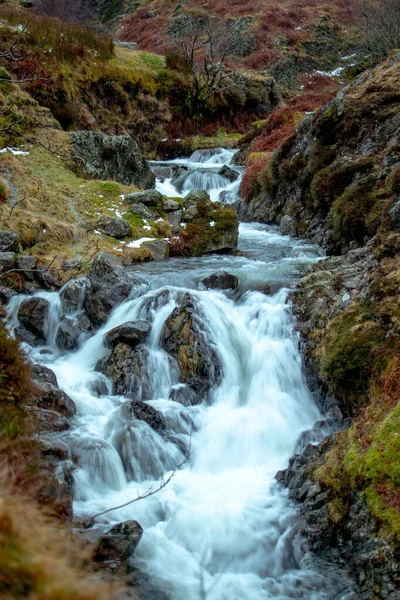 瀑布在寒冷天气下在山谷中流淌的瀑布的垂直镜头 — 图库照片